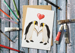 Penguins holding a Heart Balloon Greetings Card 7x5