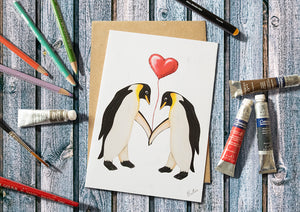 Penguins holding a Heart Balloon Greetings Card 7x5
