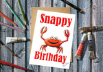 Birthday card with a red crab illustration and 'Snappy Birthday' text.